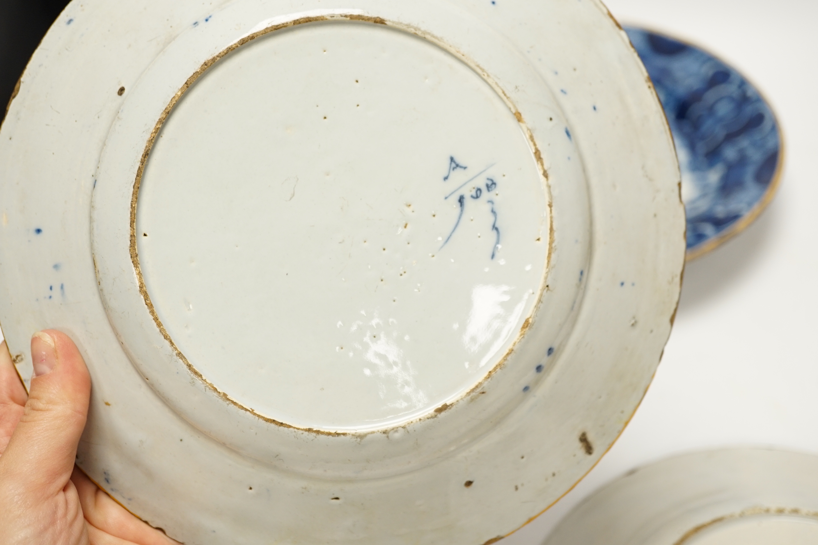 Three 18th century Delft blue and white floral dishes, 26cm in diameter